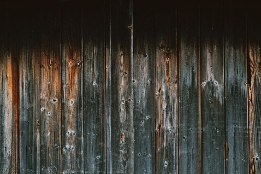 Weathered wood siding before power washing